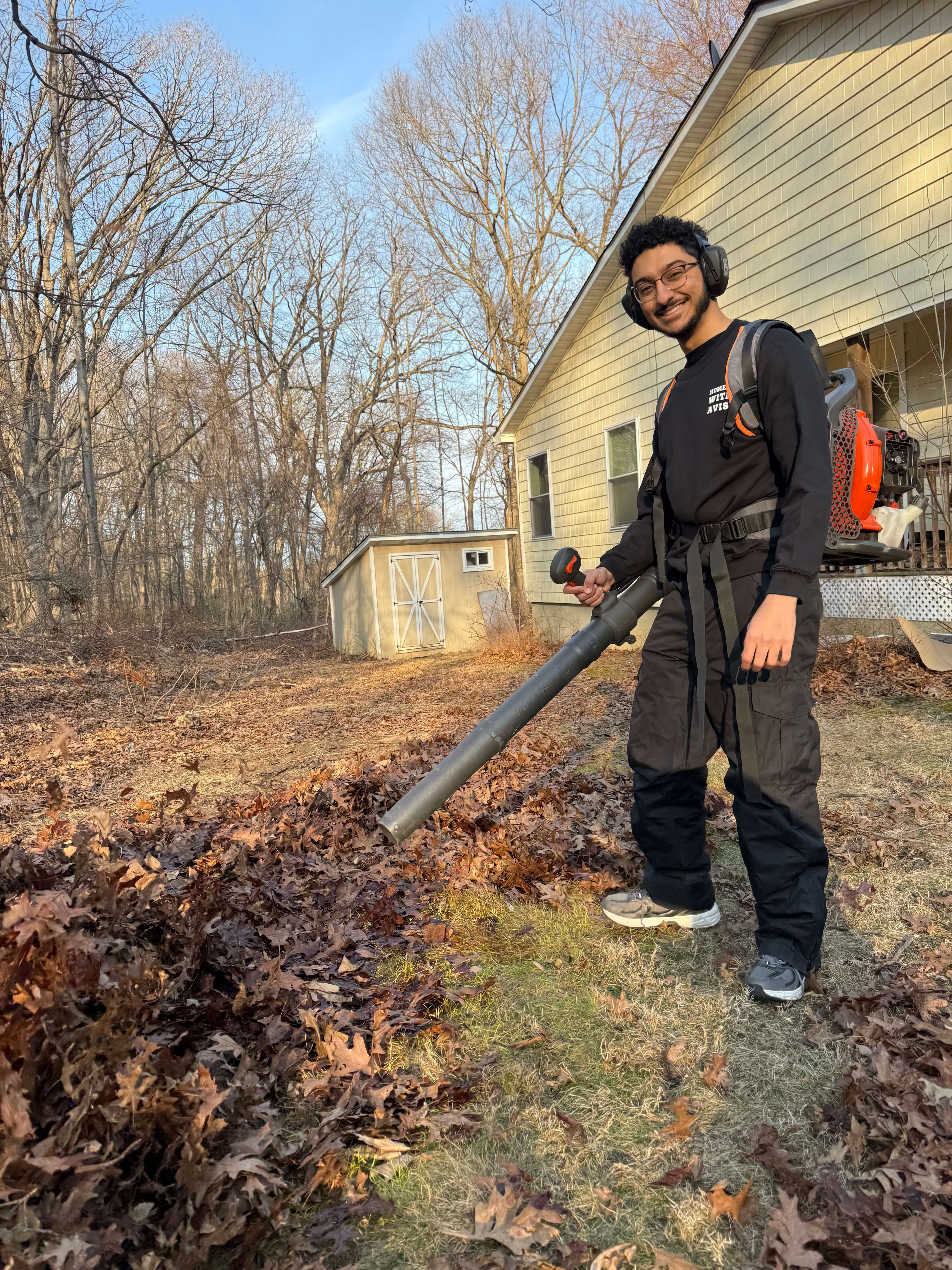 Taha — co-owner of Home Care With A Vision — performing a fall cleanup